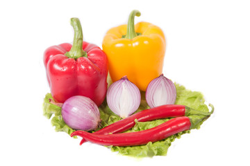 Spicy food, chili and onions lie on a lettuce leaf