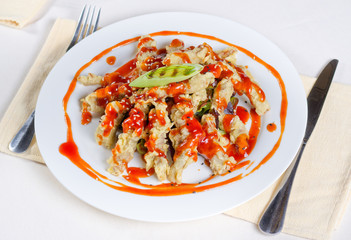 Appetizing Main Course on Table Utensils on Side