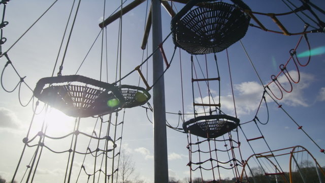 Camera movement over an empty climbing frame in a playground