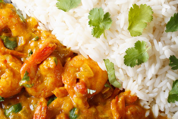 Shrimps curry with rice and cilantro macro. horizontal top view