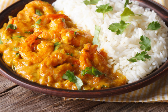 Shrimps in curry sauce with rice and cilantro horizontal