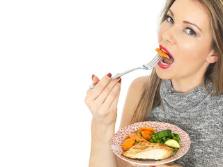 Young Woman Eating Chicken Breast with Vegetables