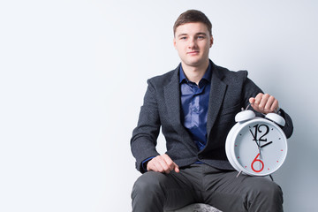 Seated Good Looking Businessman with Alarm Clock