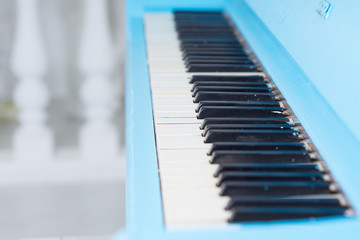 Fototapeta na wymiar View along a blue piano keyboard