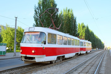 Fototapeta na wymiar Red tramway at city street