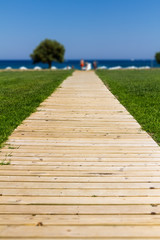Fototapeta na wymiar Wooden path to the sea - Summer vacation background