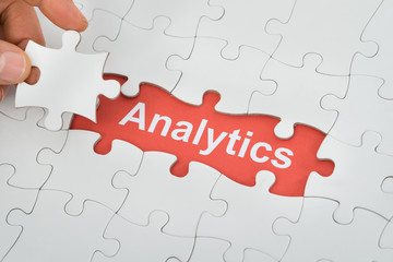 Person Holding Jig Saw Piece With Analytics Text Under Puzzle