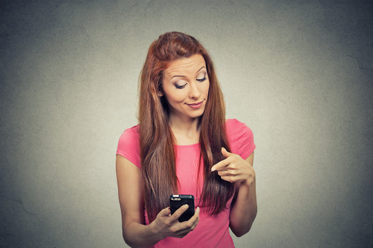 angry woman unhappy annoyed by something on cell phone