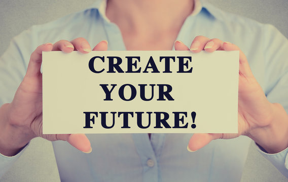 Businesswoman hands holding sign create your future message