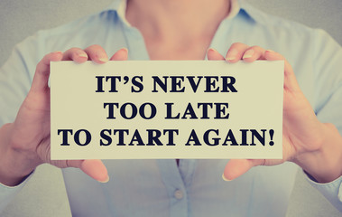 Businesswoman hands sign It's never too late to start again © pathdoc