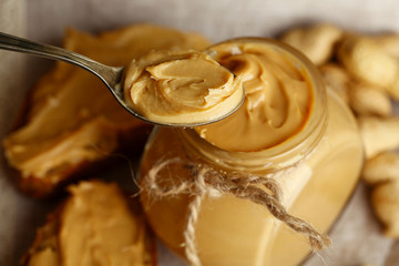 Fresh peanut butter in jar, close up