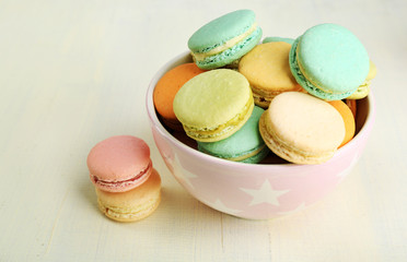 Assortment of gentle colorful macaroons in colorful bowl