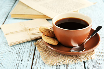 Cup of coffee with spoon and cookies
