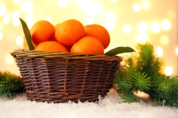 Fresh ripe mandarins in wicker basket,
