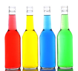 Colorful alcoholic beverages in glass bottles isolated on white
