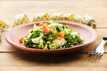 Salad with quail egg and basil in plate