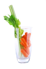 Glass of carrot, celery and parsley isolated on white