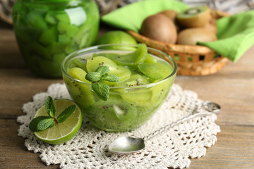 Tasty kiwi jam in glass bowl and jar