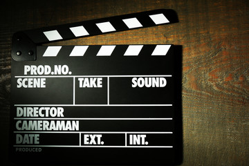 Fototapeta na wymiar Movie clapper on wooden background