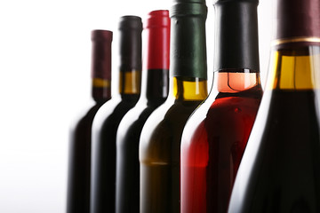 Wine bottles in row isolated on white