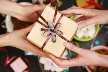 Female hands holding gift close-up