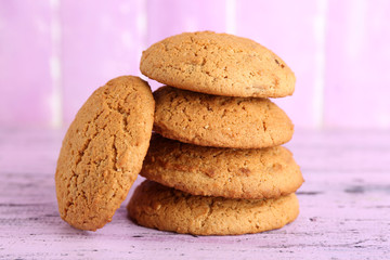 Tasty cookies on color wooden background
