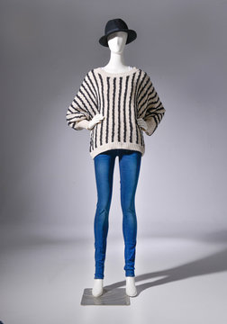 full-length female striped clothing in hat on mannequin