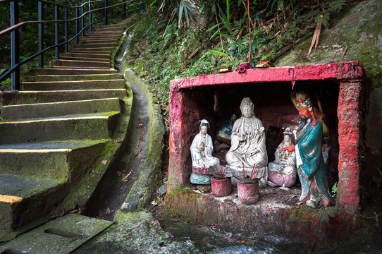 Outdoor shrine containing statues of popular Chinese gods