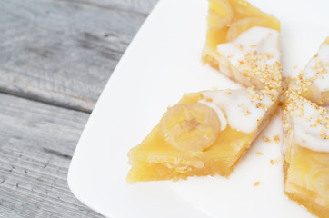 Vietnamese steamed banana cake dipped in coconut milk and sesame