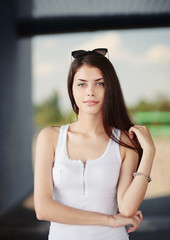 Naughty young brunette woman in a white t-shirt