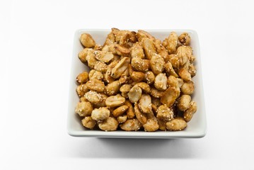 crispy peanut with sesame in plate on white background