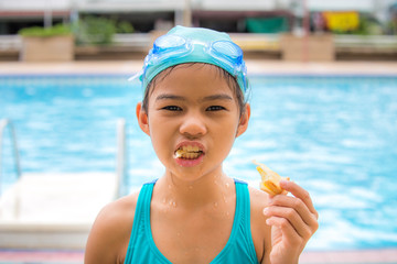 girl in swim pool eating bread
