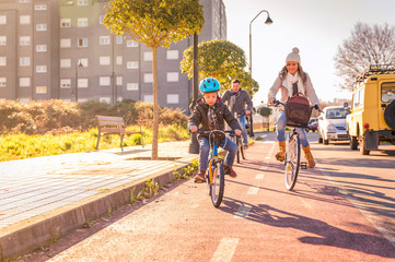 Family with child riding bicycles in the city