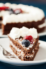 Homemade chocolate cake with cream and berries