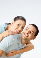Obraz premium Cheerful amorous young couple, on grey