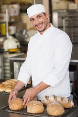 Baker checking freshly baked bread