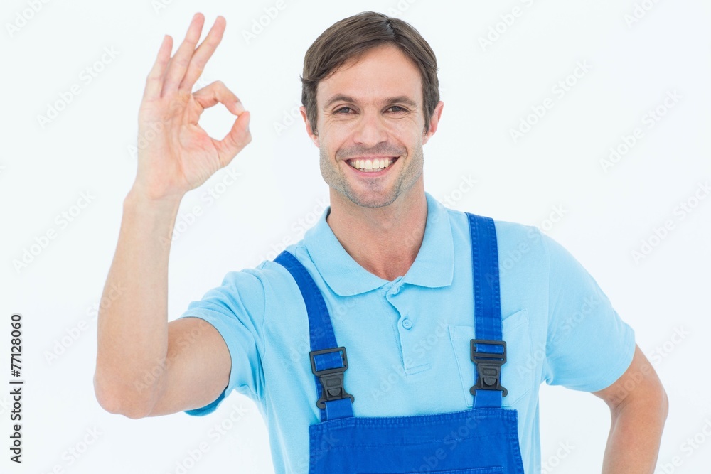 Poster smiling carpenter showing ok sign