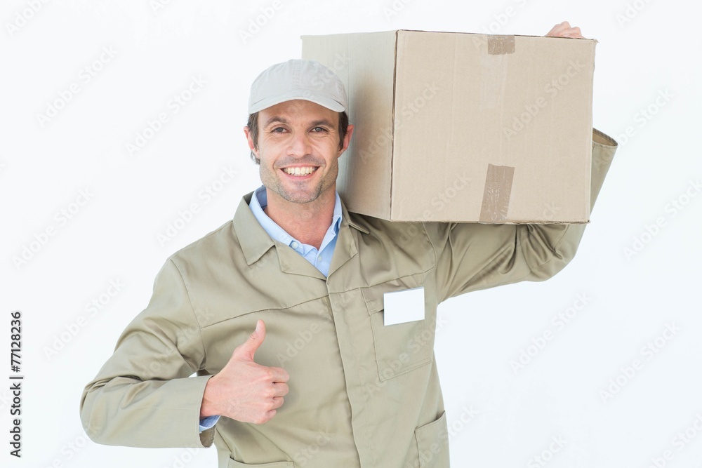 Poster delivery man showing thumbs up while carrying cardboard box