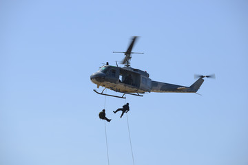 Naklejka na ściany i meble The military helicopter against the blue sky