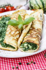 Mediterranean cuisine: crepes stuffed with cheese and spinach