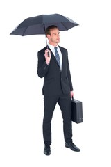 Businessman sheltering under umbrella holding briefcase