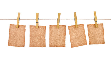 kraft paper hang from clothespins on isolated white background