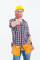 Handyman looking through adjustable wrench