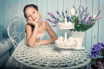 Girl with sweets on the table
