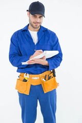 Portrait of repairman writing on document