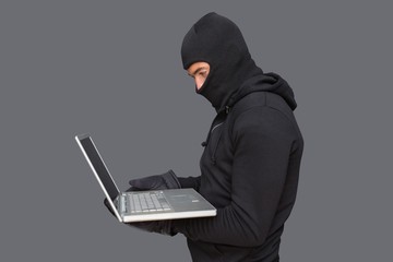 Hacker using laptop to steal identity
