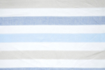 Closeup detail of blue, brown and white striped fabric