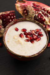 Dish of banana millet breakfast pudding with pomegranate