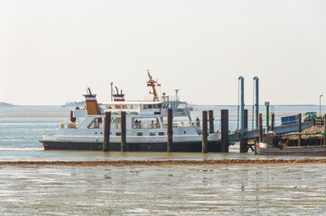Ferryboat at the quay on the Hallig Langeness in North Frisia