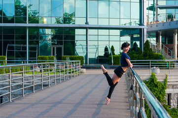 Ballet dancer in casual clothes standing on tiptoes operands